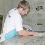 man working with granite
